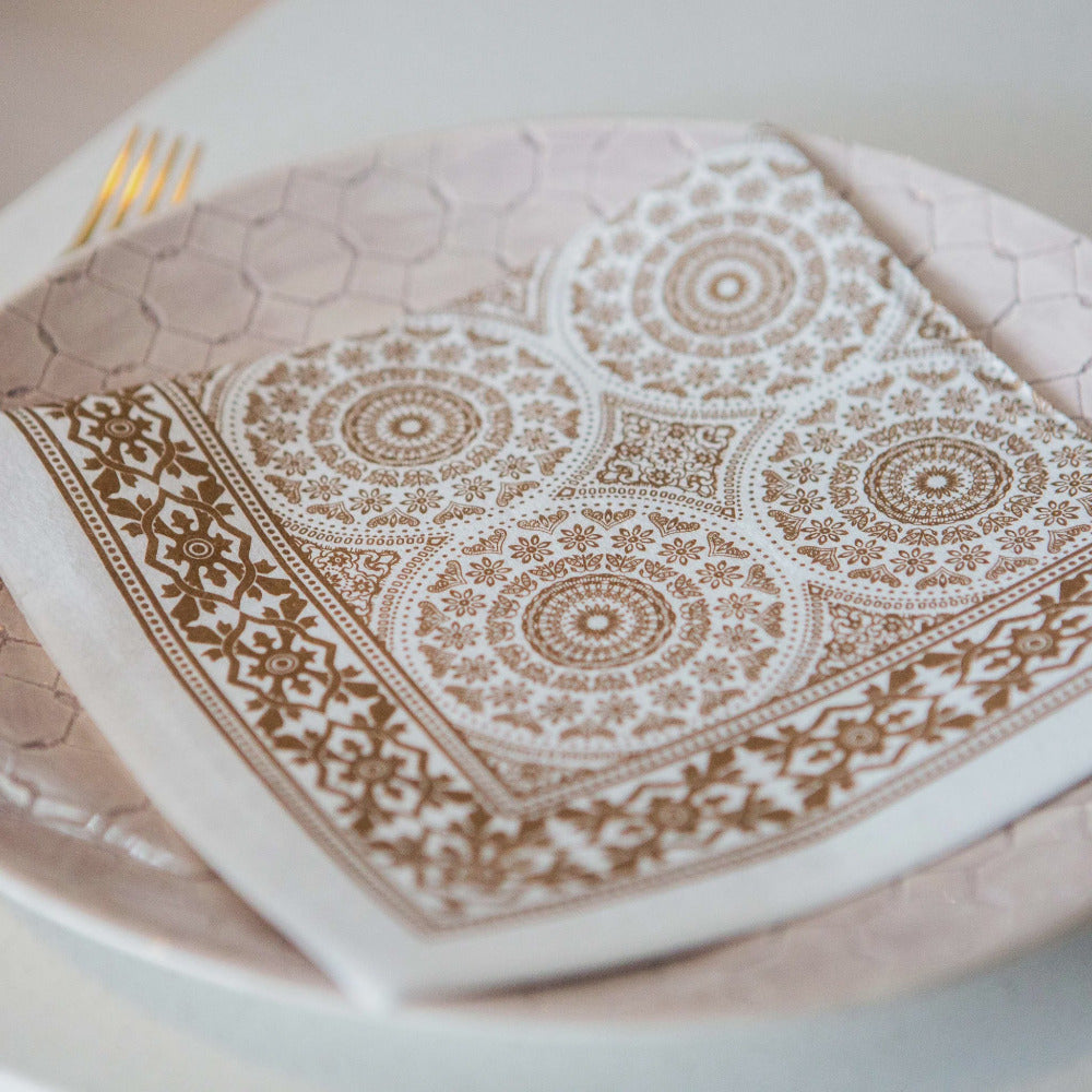 Decorative white plate with brown geometric patterns on a matching napkin.