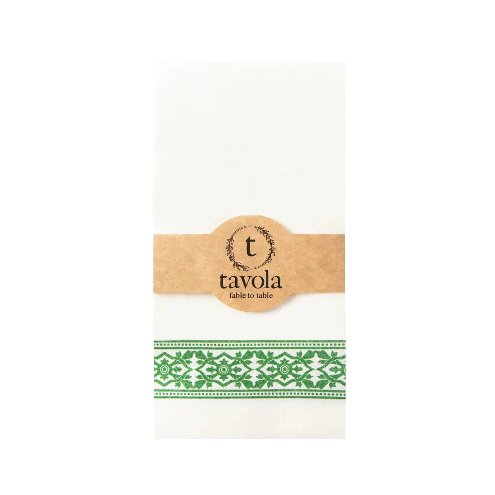 White napkin with green pattern and brown label with 'tavola' branding on a white background