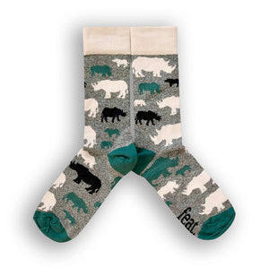 A pair of socks with a speckled grey and forest green pattern, featuring black and green rhino illustrations and the word 'FEAT' on the green toe area.