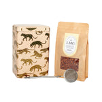 Load image into Gallery viewer, Tea packaging set with a patterned box, brown paper bag, and metal scoop on a white background

