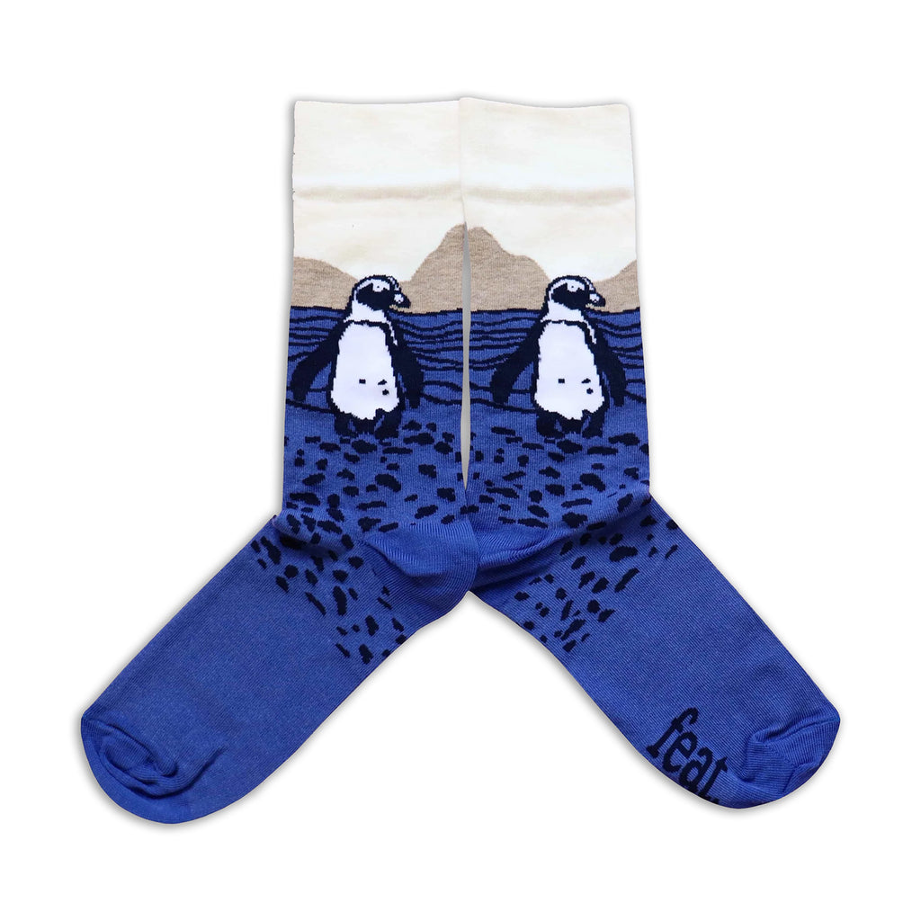 Blue socks with penguin design on a white background
