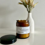 Load image into Gallery viewer, Brown candle jar labeled &#39;Japanese Garden&#39; with a black lid on a light surface.
