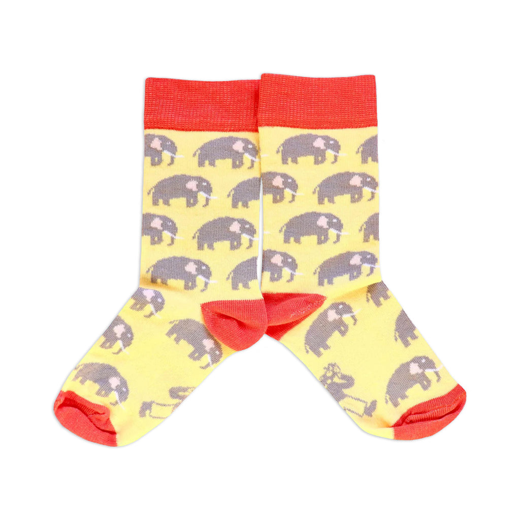 A pair of kids' socks with pale yellow and dusty orange color, featuring African elephant patterns.
