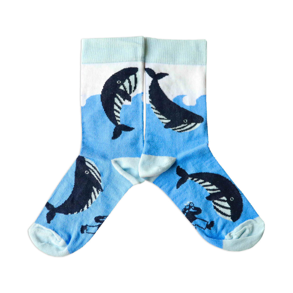 A pair of kids' blue and white cotton socks with a whale design in the waves.