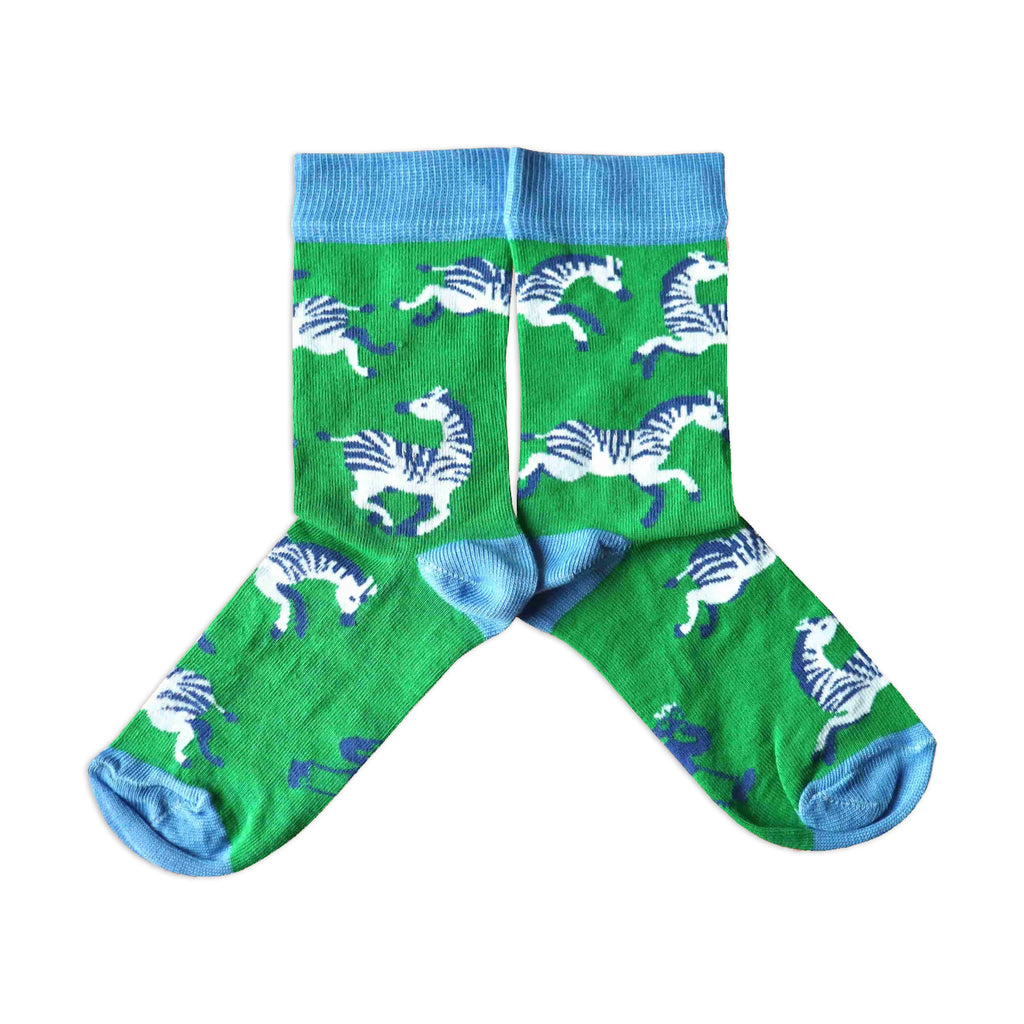 A pair of children's socks with a pattern of zebra on a green background, with blue cuffs.