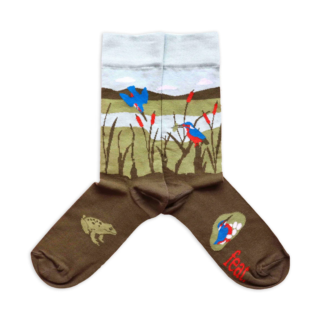 A pair of blue and brown cotton socks with blue kingfisher birds and the word 'feat' on the sole.