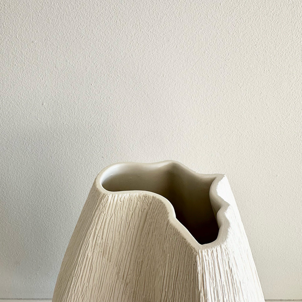 Ceramic vase with a design of the African continent on a plain background