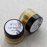 Load image into Gallery viewer, Two lip balm containers with visible branding on a light background
