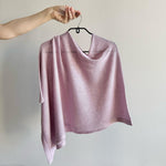 Load image into Gallery viewer, Lavender knitted poncho on a hanger against a plain background
