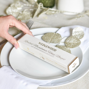 Wedgwood Roasted Macadamia Honey Nougat on a white plate with decorative leaf-shaped objects.