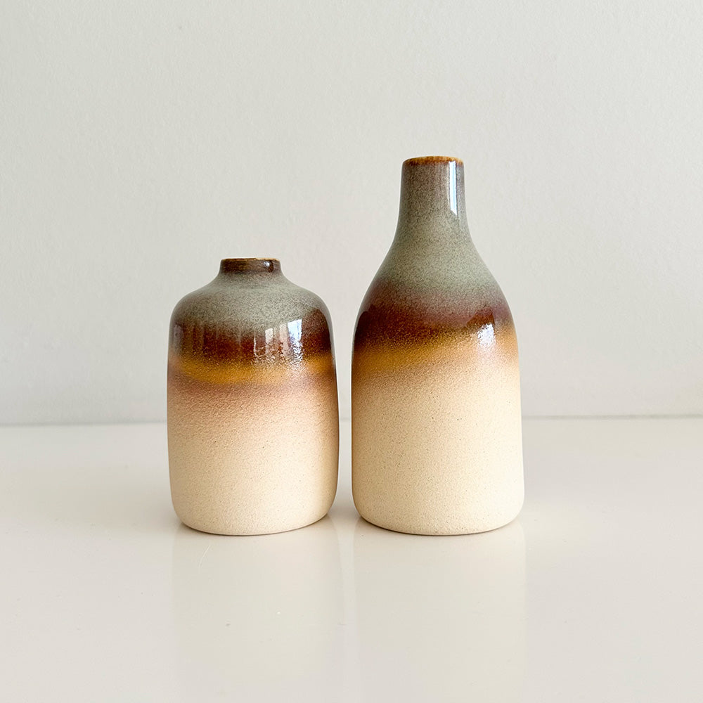 Two ceramic vases with gradient coloring on a plain background
