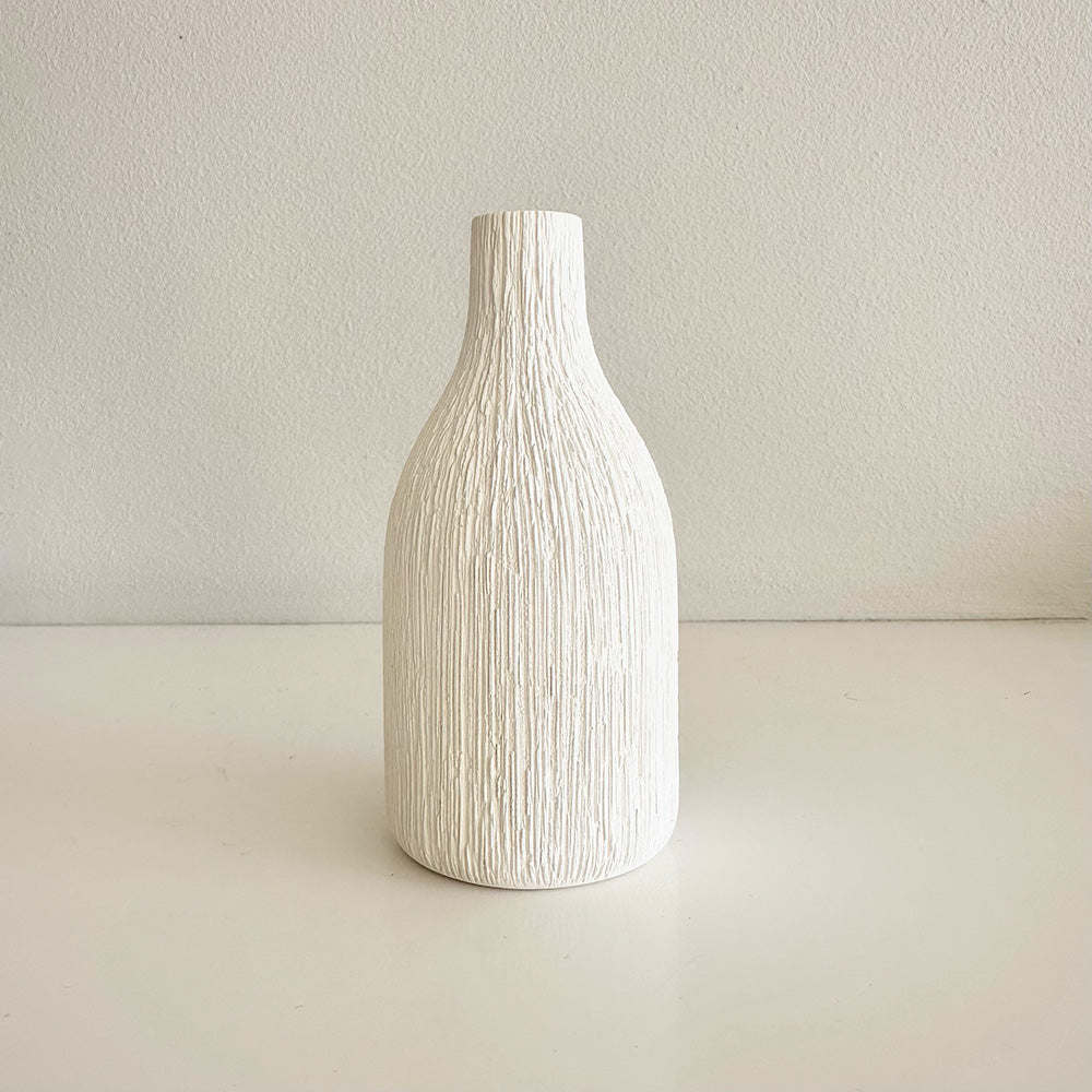 White textured vase on a light beige background