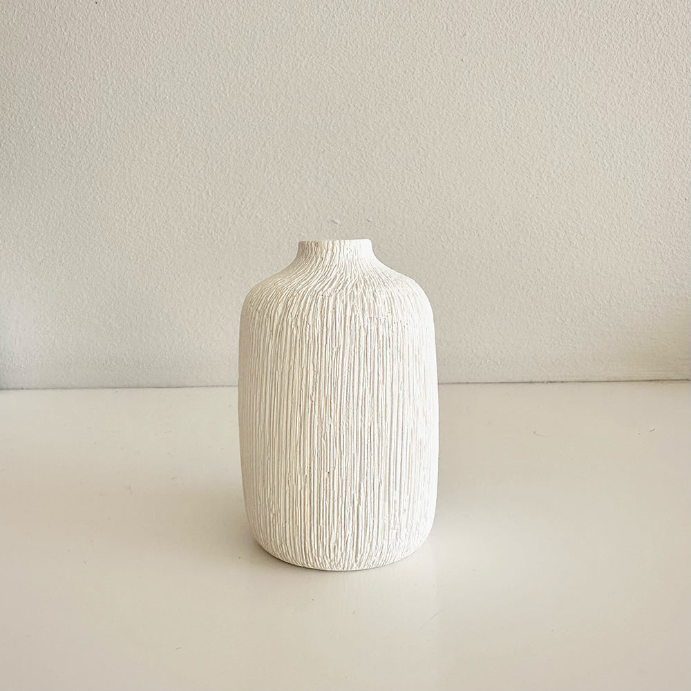 White textured vase on a light beige background