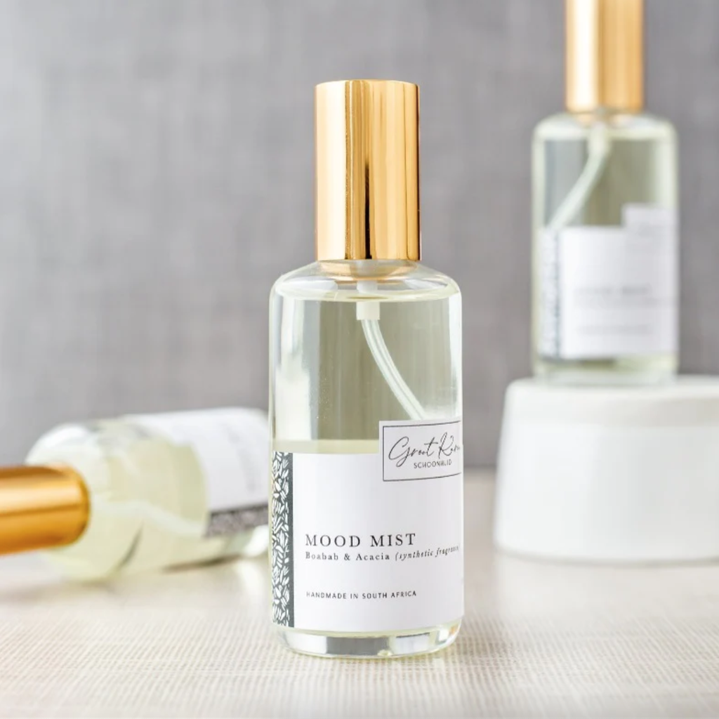Bottle of 'Mood Mist' with gold cap on a neutral background