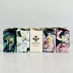 Load image into Gallery viewer, Five boxes of handmade honey nougat with floral and bee designs on a light gray background.
