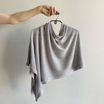 Load image into Gallery viewer, Gray knitted shawl on a hanger against a plain background
