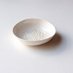 Load image into Gallery viewer, One white ceramic dipping bowl with a pincushion protea motif pressed into the base.
