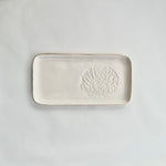 Load image into Gallery viewer, A white ceramic slate with a pincushion protea embossed on the right hand side and gold detailing on the rim. 
