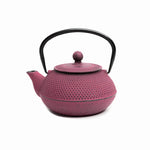 Load image into Gallery viewer, A pink cast iron teapot with a black handle.
