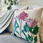 Load image into Gallery viewer, Decorative pillow with protea floral design on a couch
