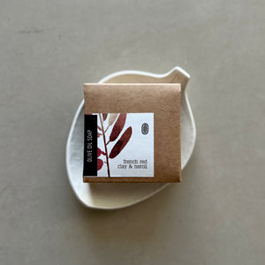 Small brown box with a label on a white plate against a gray background