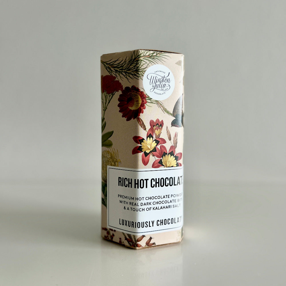 Box of rich hot chocolate with floral design on a gray background