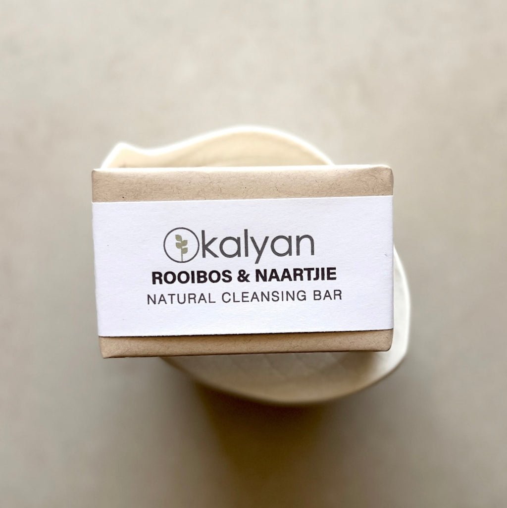 Kalyan natural cleansing bar with a white label on a beige background