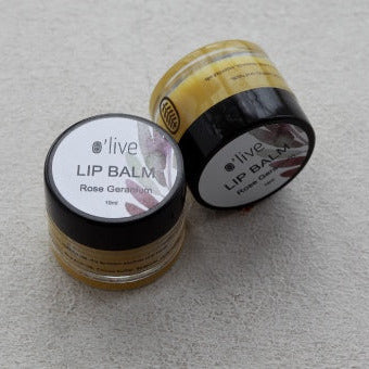 Two lip balm containers with visible labels on a light gray background