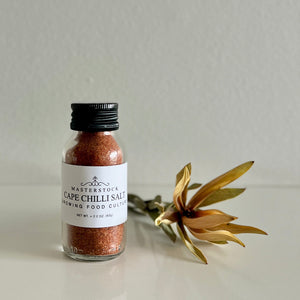 Bottle of Cape Chilli Salt with a gold flower on a light background