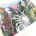 Load image into Gallery viewer, Floral design with protea flowers and leaves on a blue background
