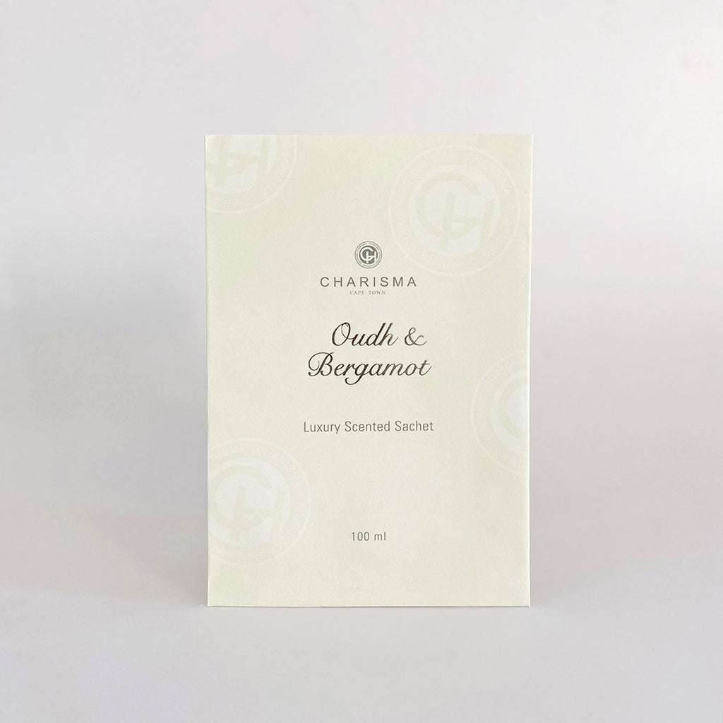 A cream coloured sachet with the title 'OUDH & BERGAMOT LUXURY SCENTED SACHET' in silver foiling.