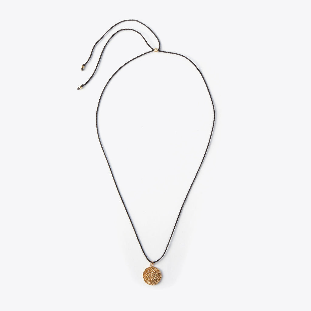Necklace with a bronze pendant on a white background