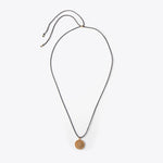 Load image into Gallery viewer, Necklace with a bronze pendant on a white background
