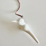 Load image into Gallery viewer, White ceramic bird ornament on a plain background
