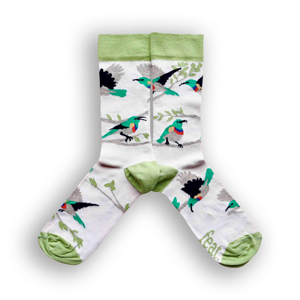 A pair of beige and green cotton socks with an illustration of Lesser Double-collared Sunbirds.