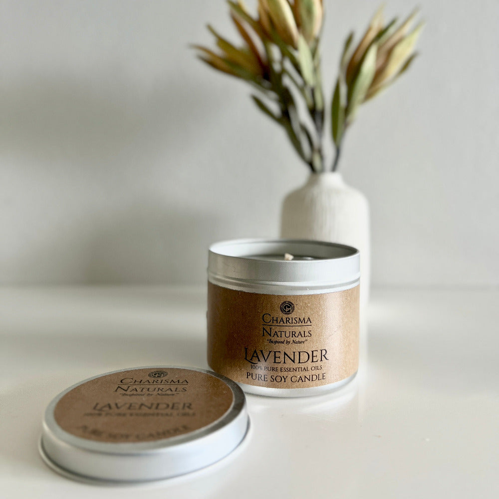 Lavender candle in a tin with Charisma Naturals branding on a neutral background