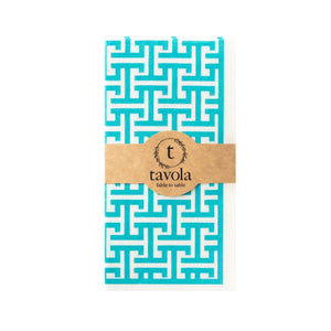 Turquoise and white patterned napkin with a brown label on a white background.