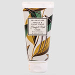 Load image into Gallery viewer, Hand and nail cream tube with leaf design and visible brand name on a light gray background
