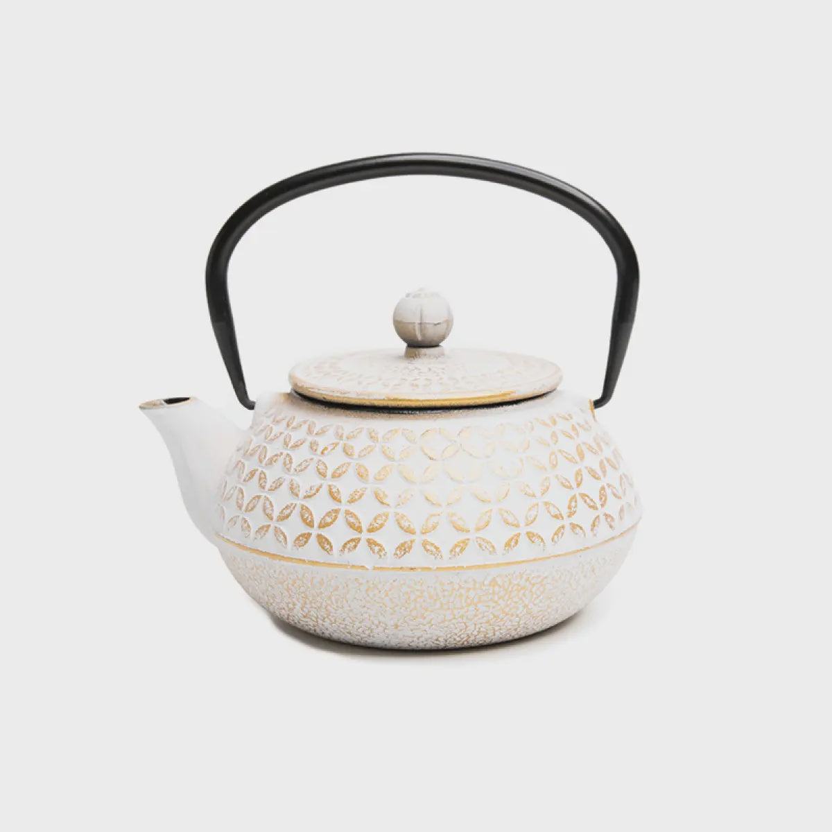 A white cast iron teapot and a black handle, designed in a Japanese style with gold accents.
