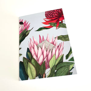 A6 greeting card with pink and red floral design on a light blue background