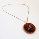 Load image into Gallery viewer, A brass chain necklace featuring a protea seed pod pendant.
