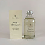 Load image into Gallery viewer, A glass bottle and a box packaging for a scented diffuser refill, with the label &#39;Oudh &amp; Bergamot&#39; and &#39;Luxurious Scented Diffuser Refill&#39;.
